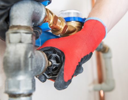 Residential Water Pipeline Valve Closing. Plumbing Industry Concept. Caucasian Plumber Worker.